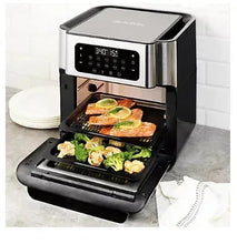 Multifunctional air fryer with open basket, black pepper and stainless steel, vegetables and chicken visible