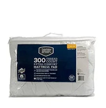 Twin-size extra comfort mattress pad, packaged in clear plastic bag
