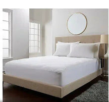 White queen mattress pad topper fitted on bed with elastic-corner fit