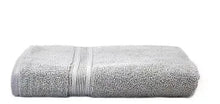 Gray bath towel, rolled and folded with striped border detail