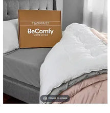 King size comforter on bed, white quilted cover with box packaging behind
