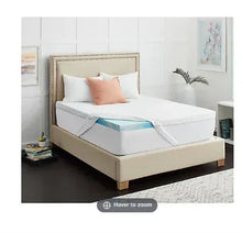 Sealy 3-inch queen mattress topper with zip cover on bed, white quilted surface