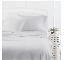 White satin bed sheet set with flat sheet and pillowcases, neatly arranged