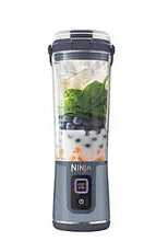 Portable blender with denim blue power base, clear jar, and locking lid