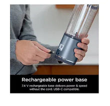 Portable blender power base held in hand, with cylindrical blending jar