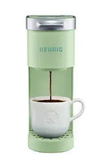 Keurig K-Mini single-serve coffee maker in chill green with mug and hot coffee