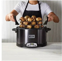 Black indoor smoker and slow cooker with lid, handles, and food on rack inside