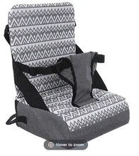 Travel booster seat with gray base, zigzag patterned seat pad and black straps