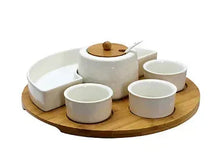 Lazy Susan appetizer set with wooden turntable, ceramic cups, and central lidded holder