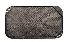 Black reversible grill and griddle with ridged cooking surface and corner rivets
