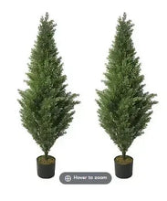 Pair of faux cypress topiary trees, green leaves, in dark plastic pots
