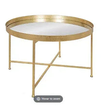 Round coffee table with gold frame and dark glass tabletop