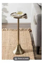 Gold drink table with round top and slender pedestal base.