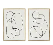 Framed abstract circle wall art set, two gold frames, black line circles on linen canvas.