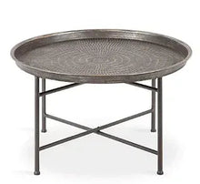 Hammered metal round tray top coffee table in brushed silver with cross-brace legs