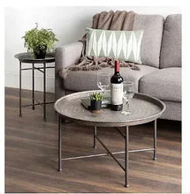 Brushed silver hammered metal round coffee table with three-leg base and tray top