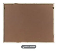 Back of framed wall art with plain brown panel and hanging hardware at corners