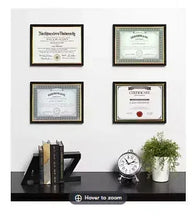 Black certificate document frames showing four certificates in gold and dark mats
