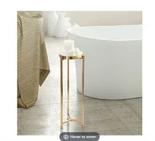 Modern drink table with round white top and gold metal frame