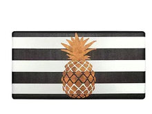 Anti-fatigue kitchen mat with black-and-white stripes and gold pineapple print