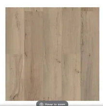 Weathered vinyl plank flooring close-up with light woodgrain texture