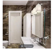 Chrome bathroom faucet and vanity sink with white cabinet and mirror