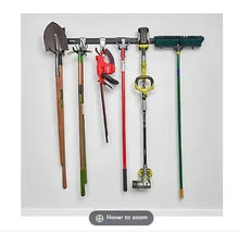 Wall tool storage rail with hooks, holding shovels and hand tools