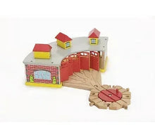 Toy train roundhouse set with red turntable track and small buildings