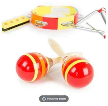 Toy percussion set close-up of striped maracas with red-and-yellow drum and harmonica
