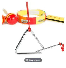 Toy percussion set showing red drum, tambourine, triangle percussion frame, and maraca