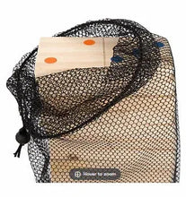 Giant wooden domino tiles inside a black mesh storage bag
