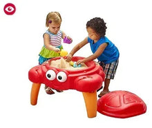 Red crab-themed sand table with round legs and molded play tray for sand.