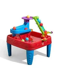 Colorful plastic STEM discovery ball table with red base, blue sides, multicolor ramps
