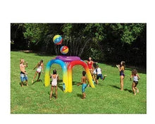 Inflatable giant sprinkler with rainbow frame and floating spray ball in an outdoor yard