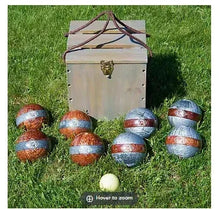 Wooden bocce storage box with brass latch and multiple bocce balls