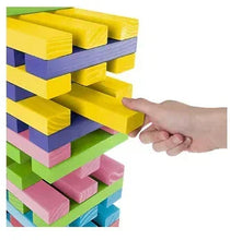 Wooden stacking blocks tower with multicolor bars, hand moving a block