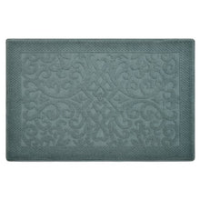 Teal textured bath mat with raised swirl and diamond pattern