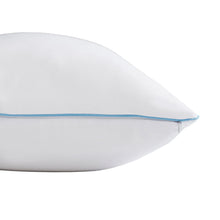 White pillow protector with blue piping along edge and close-up corner seam.