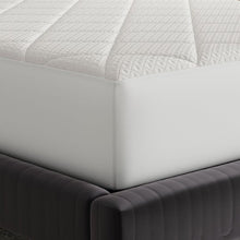 White quilted mattress pad corner with fitted side panel