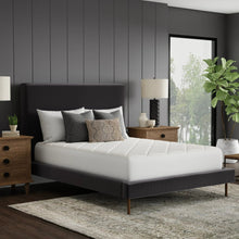 White quilted mattress pad on bed top surface