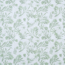White-and-light-green botanical microfiber fabric close-up with leaf pattern