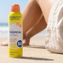 Tropical SPF 50 quick-dry sunscreen spray bottle, yellow with orange flip-top cap