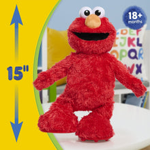 Red Elmo plush standing with outstretched arms, round eyes and orange nose