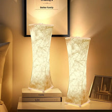 Pair of tall fabric table lamps with textured white shades, warm light glow