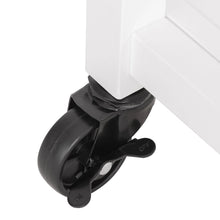 Black swivel caster wheel with lock on a white kitchen cart