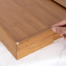 Bamboo drawer organizer with sliding side panel and round support knobs