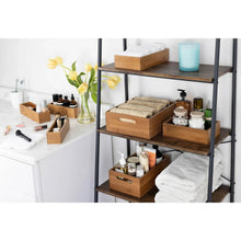Bamboo bathroom organizer bins for towels, toiletries, and storage jars on shelves