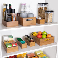 Bamboo organizer starter set bins arranged on shelves with jars and fruit