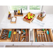 Bamboo organizer starter set with multiple compartment trays on a countertop