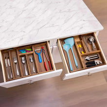 Wood drawer organizer set open with utensil compartments for kitchen tools